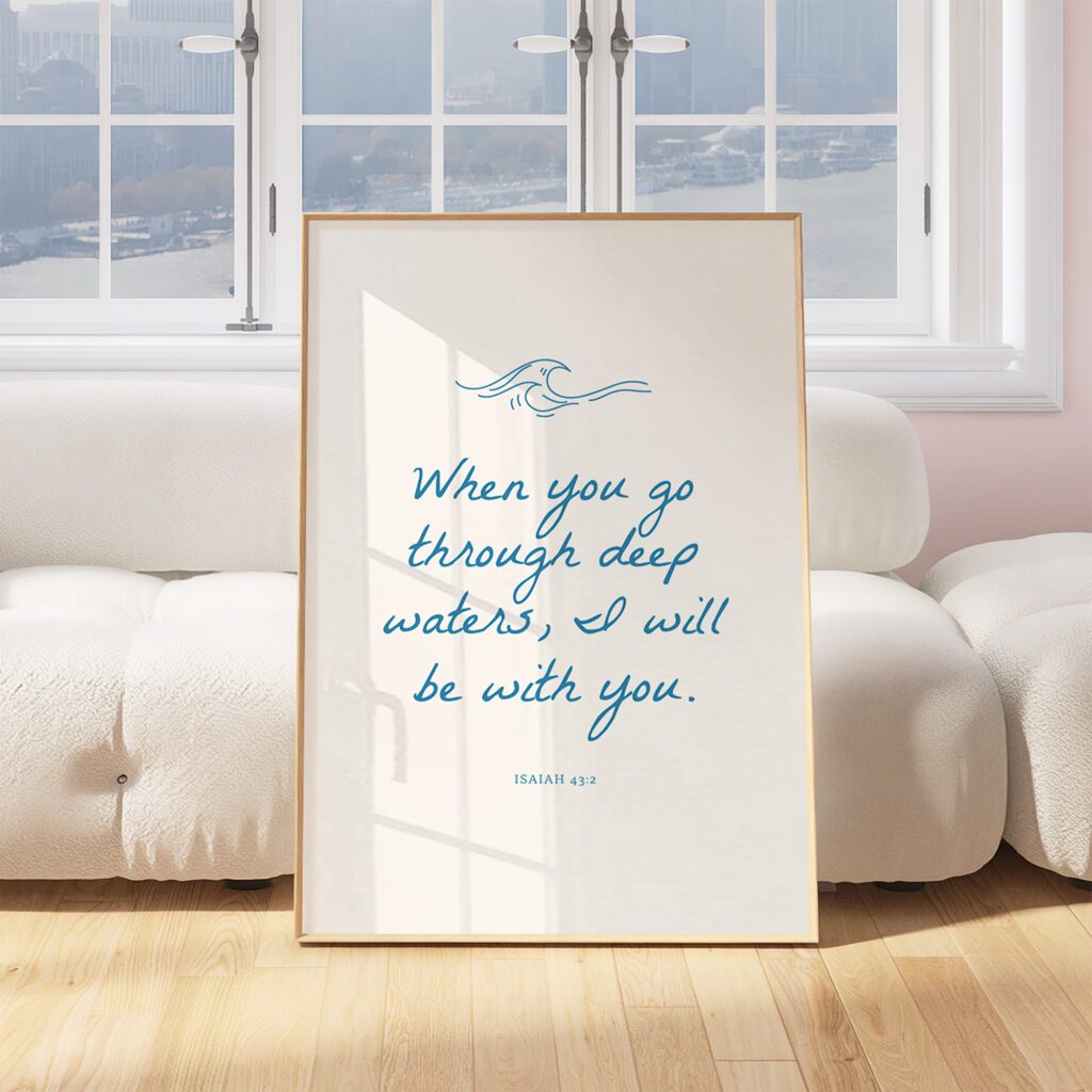 Framed quote with waves design: When you go through deep waters, I will be with you. Isaiah 43:2 on a sofa.