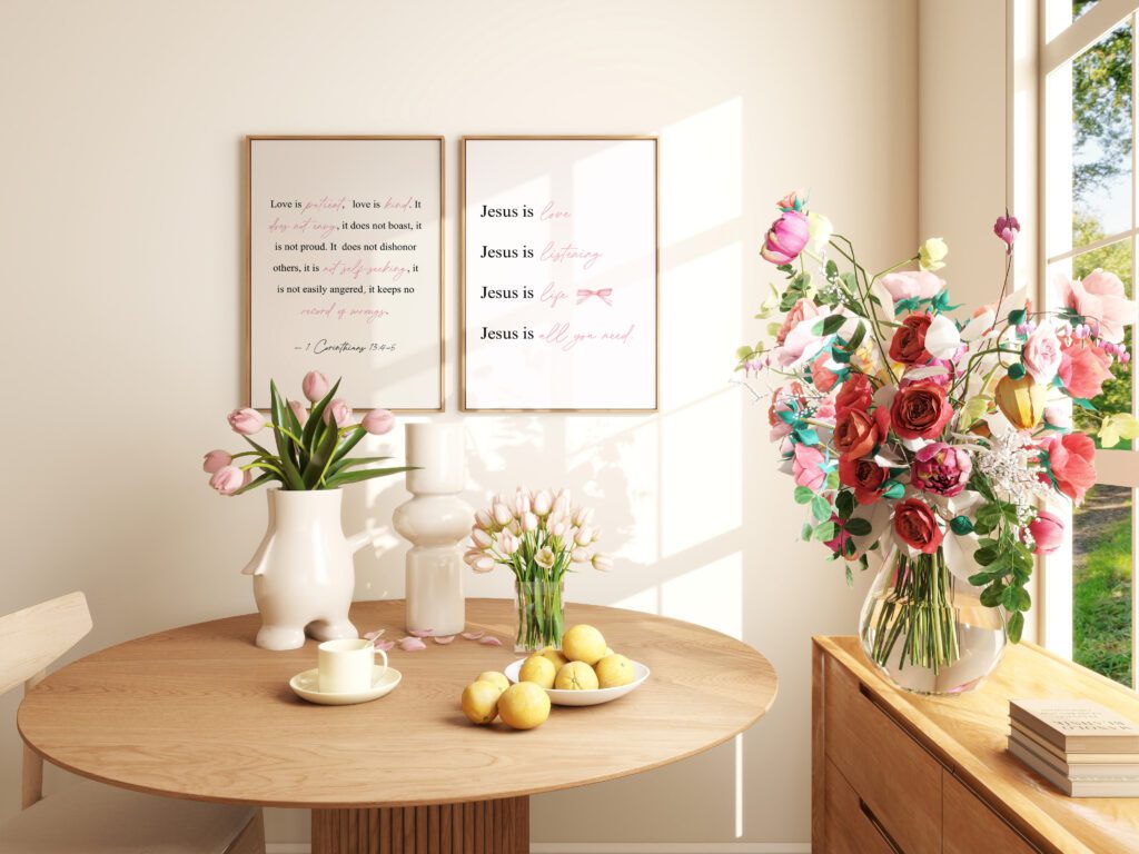 Sunlit dining area with a round table, flowers, lemons, and framed quotes on the wall.